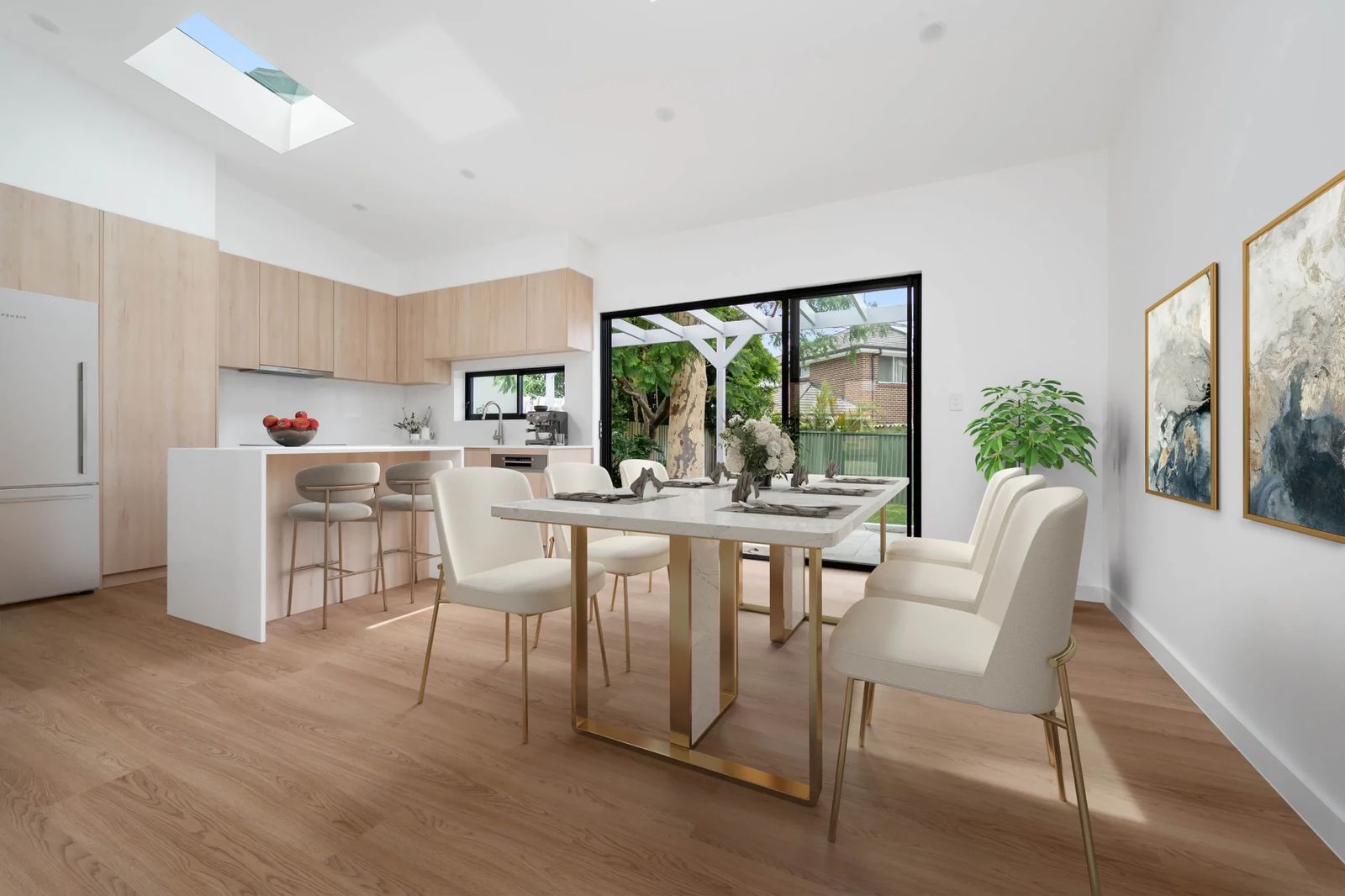 Monash Gardens, Pagewood — After renovation — open-plan dining and kitchen with skylight, marble table and alfresco access