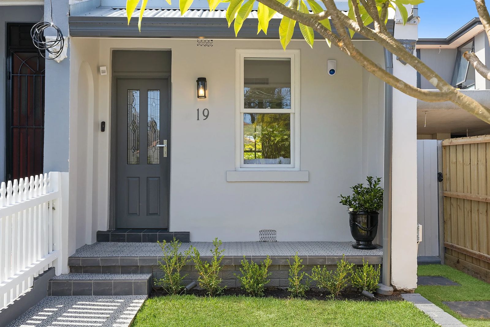 Middle Street, Marrickville — After renovation — refreshed front facade with grey feature door, tiled verandah and white picket fence